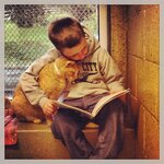 books-boy-reading-to-cat-in-shelter-per-Berks-County-Animal-Rescue.jpg